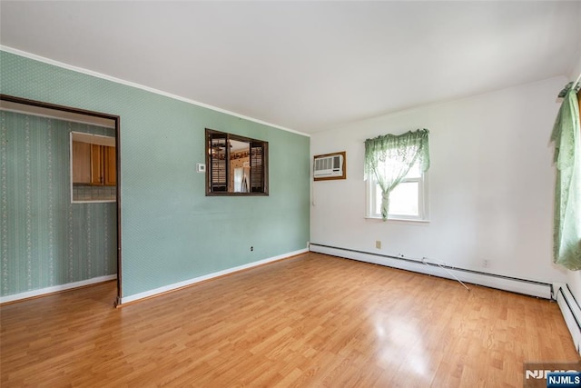 57 Burnside, Wanaque, NJ 07420 - spare room with a baseboard radiator, wood finished floors, crown molding, a wall mounted AC, and baseboards