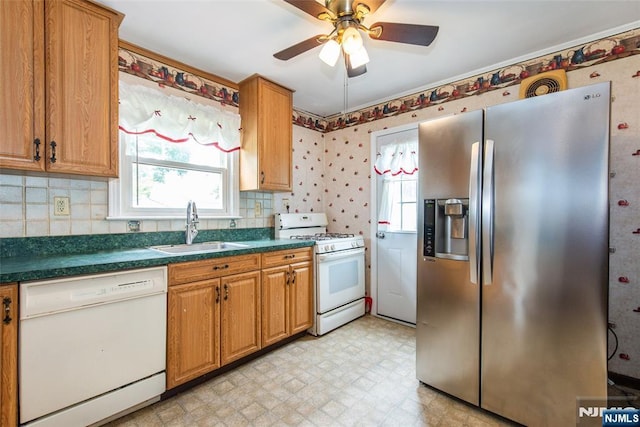 57 Burnside, Wanaque, NJ 07420 - kitchen with white appliances, a sink, dark countertops, plenty of natural light, and wallpapered walls