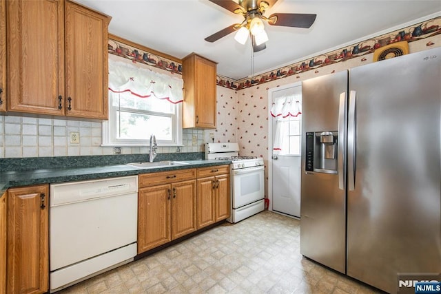 57 Burnside, Wanaque, NJ 07420 - kitchen featuring white appliances, a sink, healthy amount of natural light, and dark countertops