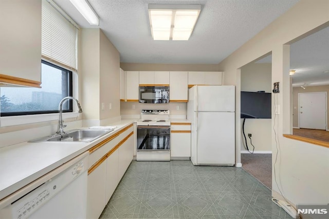 200 Division Unit 6H, Cliffside Park, NJ 07010 - kitchen with white appliances, a sink, light countertops, white cabinetry, and a textured ceiling