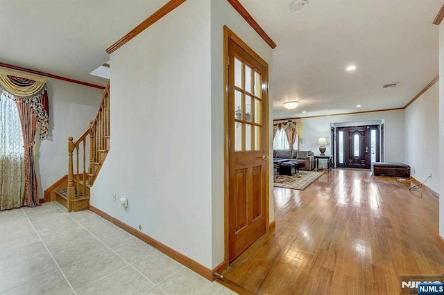 238 E Johnson Ave, Bergenfield, NJ 07621 - foyer with crown molding, stairs, baseboards, and wood finished floors