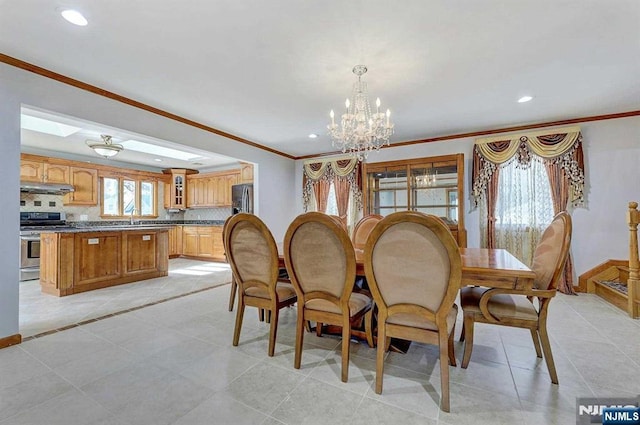 238 E Johnson Ave, Bergenfield, NJ 07621 - dining area featuring ornamental molding, a chandelier, recessed lighting, light tile patterned floors, and baseboards
