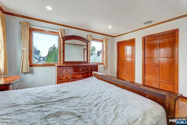 238 E Johnson Ave, Bergenfield, NJ 07621 - bedroom featuring multiple closets, crown molding, and recessed lighting