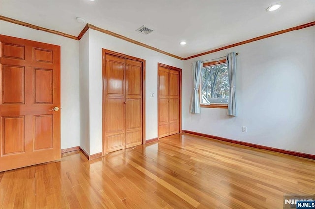 238 E Johnson Ave, Bergenfield, NJ 07621 - unfurnished bedroom featuring multiple closets, light wood-type flooring, baseboards, recessed lighting, and crown molding