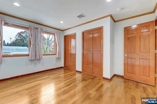 238 E Johnson Ave, Bergenfield, NJ 07621 - unfurnished bedroom with multiple closets, light wood-style floors, baseboards, ornamental molding, and recessed lighting