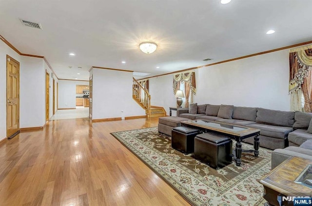 238 E Johnson Ave, Bergenfield, NJ 07621 - living area featuring crown molding, stairs, light wood-style floors, recessed lighting, and baseboards
