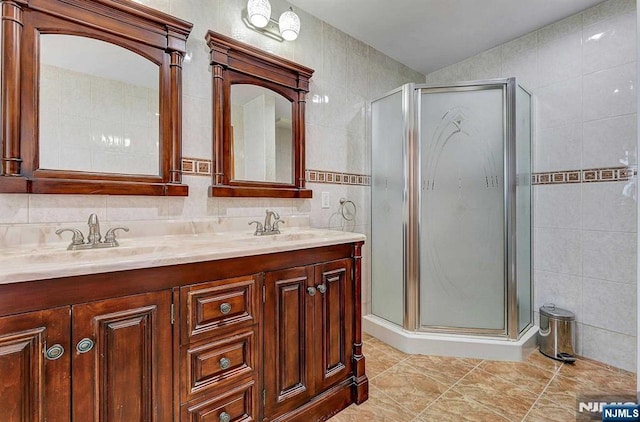 238 E Johnson Ave, Bergenfield, NJ 07621 - full bath featuring tile walls, double vanity, a stall shower, and tile patterned floors