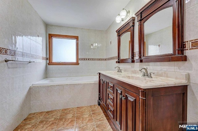 238 E Johnson Ave, Bergenfield, NJ 07621 - full bath with tile walls, tiled bath, and double vanity