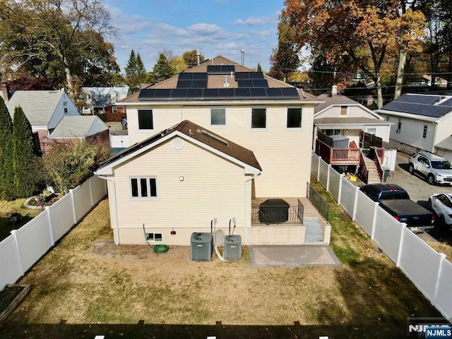 238 E Johnson Ave, Bergenfield, NJ 07621 - rear view of property featuring roof mounted solar panels and central air condition unit