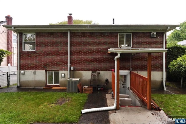 300 Mohegan Way, Fort Lee, NJ 07024 - rear view of house with brick siding, a chimney, central AC unit, and entry steps