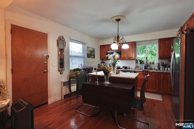 300 Mohegan Way, Fort Lee, NJ 07024 - dining room featuring radiator, dark wood-style floors, and healthy amount of natural light