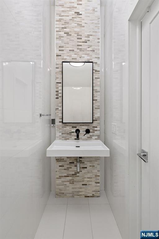 443 Albany Ct Unit 443, West New York, NJ 07093 - bathroom featuring tile walls, tile patterned flooring, and a sink
