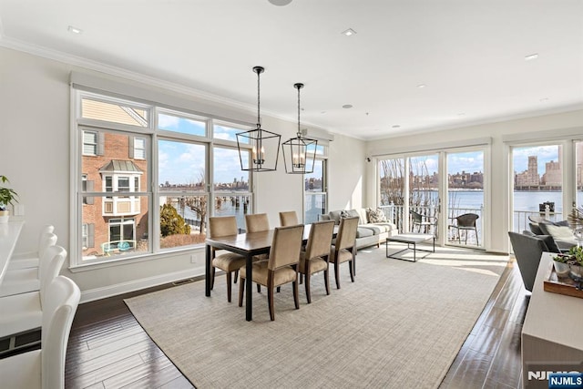 443 Albany Ct Unit 443, West New York, NJ 07093 - dining room featuring a water view, ornamental molding, wood finished floors, a chandelier, and baseboards