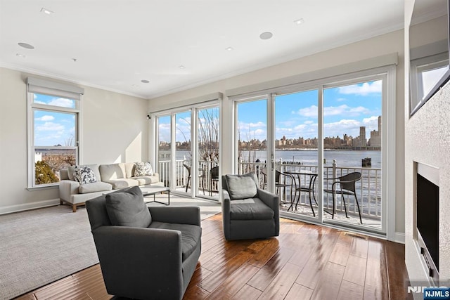 443 Albany Ct Unit 443, West New York, NJ 07093 - living area with wood finished floors, a water view, crown molding, healthy amount of natural light, and baseboards