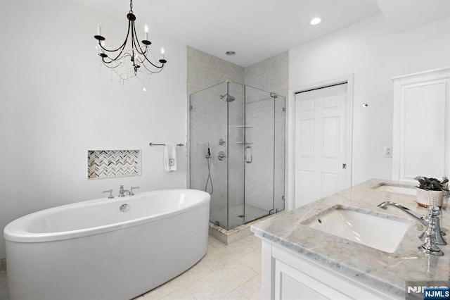 443 Albany Ct Unit 443, West New York, NJ 07093 - full bathroom with a freestanding bath, a stall shower, double vanity, recessed lighting, and a chandelier