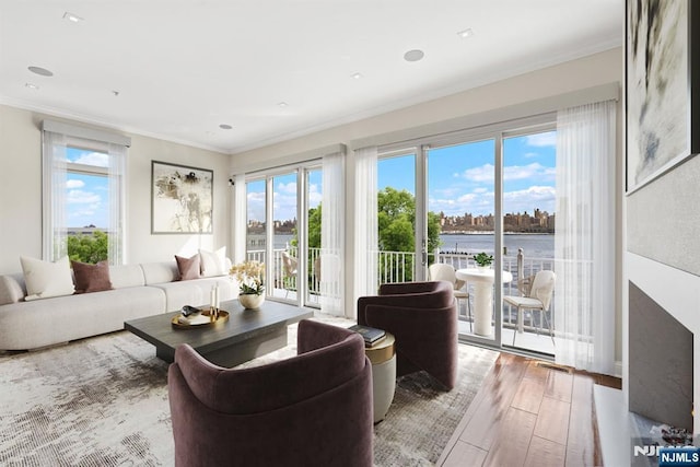 443 Albany Ct Unit 443, West New York, NJ 07093 - living room featuring a water view, ornamental molding, and wood finished floors