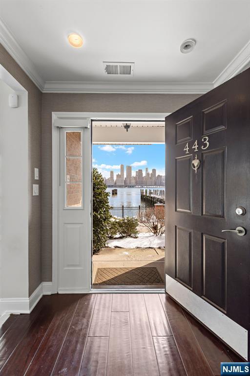 443 Albany Ct Unit 443, West New York, NJ 07093 - entrance foyer with crown molding, dark wood-style floors, baseboards, a water view, and a skyline view