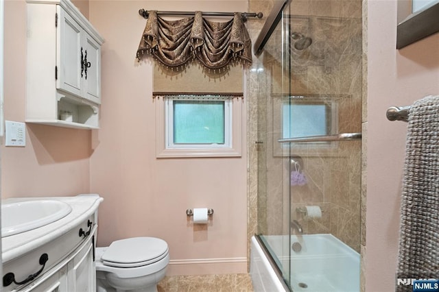 33 Irwin Pl, Bloomfield, NJ 07003 - full bathroom featuring vanity, toilet, shower / bath combination with glass door, and baseboards