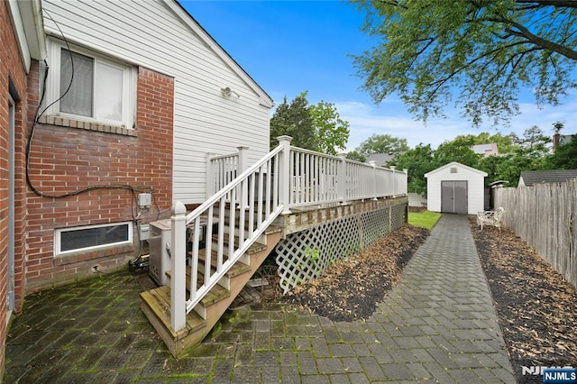 33 Irwin Pl, Bloomfield, NJ 07003 - view of home's exterior with a deck, brick siding, and a fenced backyard
