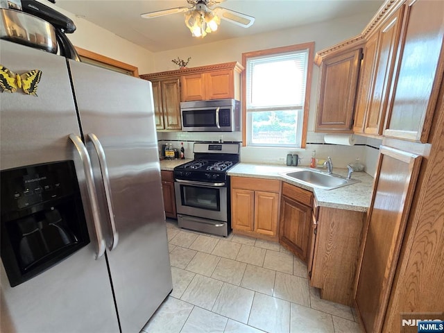 18 W Broad St, Bergenfield, NJ 07621 - kitchen featuring appliances with stainless steel finishes, a sink, light countertops, ceiling fan, and backsplash