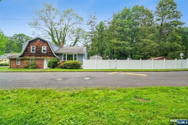 69 Bogert Pl, Bergenfield, NJ 07621 - view of front of home featuring a gambrel roof and a chimney