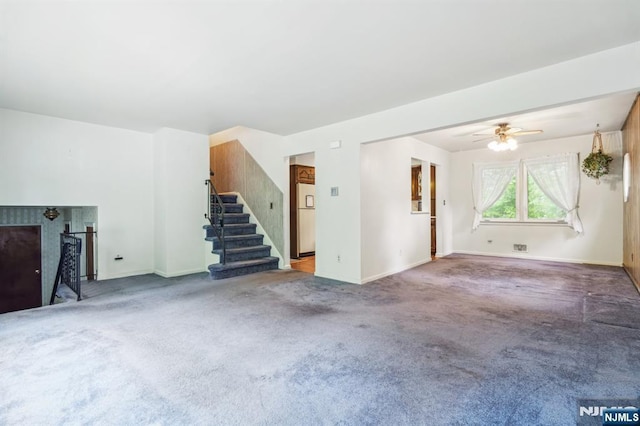69 Bogert Pl, Bergenfield, NJ 07621 - unfurnished living room with stairs, baseboards, carpet flooring, and a ceiling fan