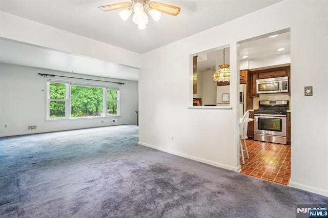 69 Bogert Pl, Bergenfield, NJ 07621 - unfurnished living room with baseboards, ceiling fan, carpet floors, and brick patterned floors