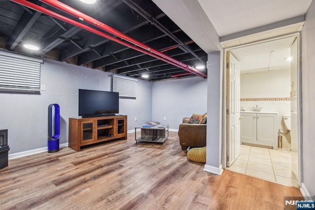 24 Willet, Bloomfield, NJ 07003 - finished basement featuring wood finished floors, a sink, and baseboards