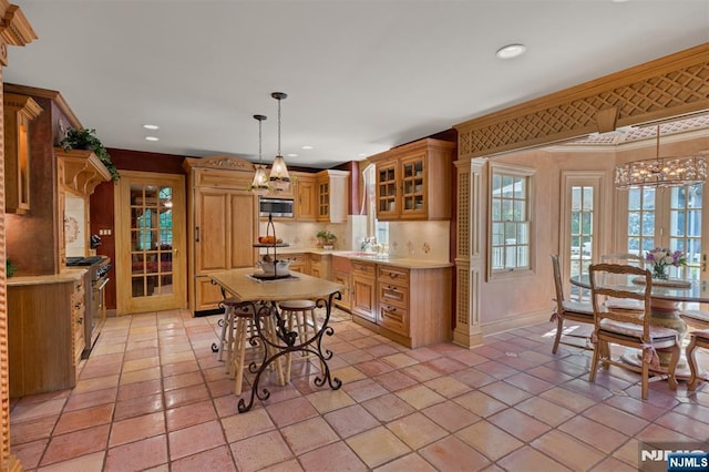 2 Olde Lantern Ct, Montvale, NJ 07645 - kitchen featuring stainless steel appliances, light countertops, a chandelier, glass insert cabinets, and recessed lighting