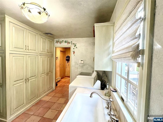 2 Olde Lantern Ct, Montvale, NJ 07645 - laundry area with cabinet space, separate washer and dryer, baseboard heating, light tile patterned floors, and a textured ceiling