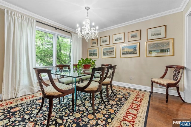 430 Jones Rd, Englewood, NJ 07631 - dining space with a chandelier, crown molding, baseboards, and wood finished floors
