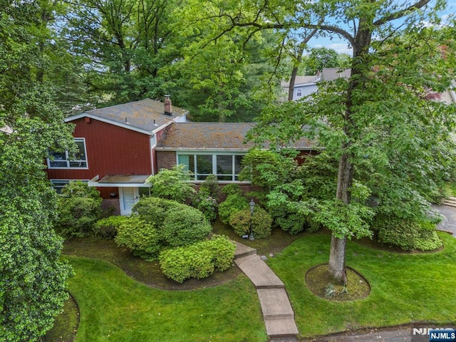 430 Jones Rd, Englewood, NJ 07631 - view of front facade with a front lawn, a chimney, and brick siding