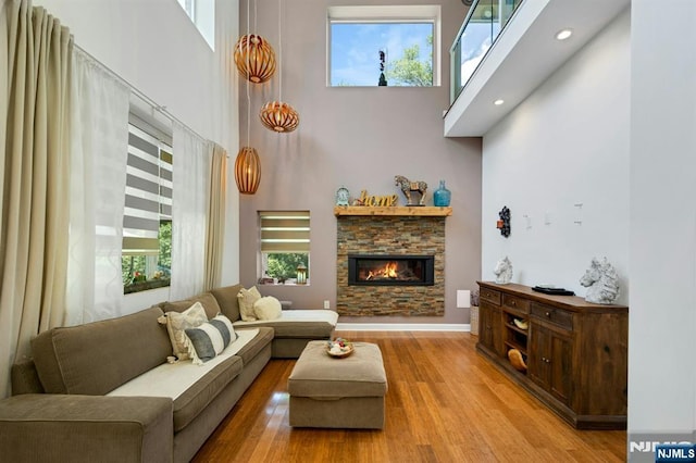 21 Sheridan Ave, West Orange, NJ 07052 - living area with a high ceiling, wood finished floors, a stone fireplace, and recessed lighting