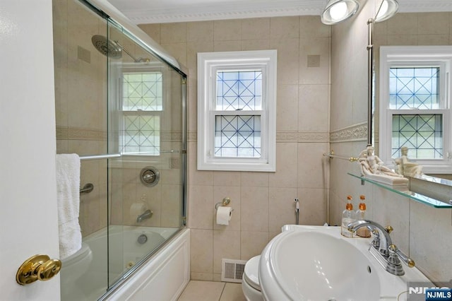 21 Sheridan Ave, West Orange, NJ 07052 - bathroom with a sink, crown molding, tile walls, enclosed tub / shower combo, and toilet