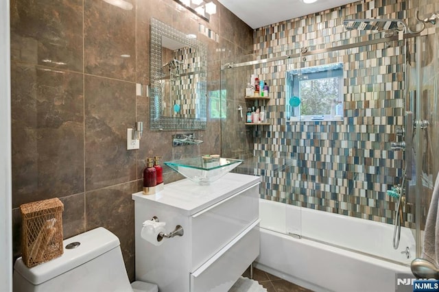 21 Sheridan Ave, West Orange, NJ 07052 - full bathroom with tile walls, enclosed tub / shower combo, vanity, toilet, and tile patterned flooring
