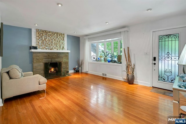 21 Sheridan Ave, West Orange, NJ 07052 - living room with light wood-style flooring, a stone fireplace, baseboards, and recessed lighting