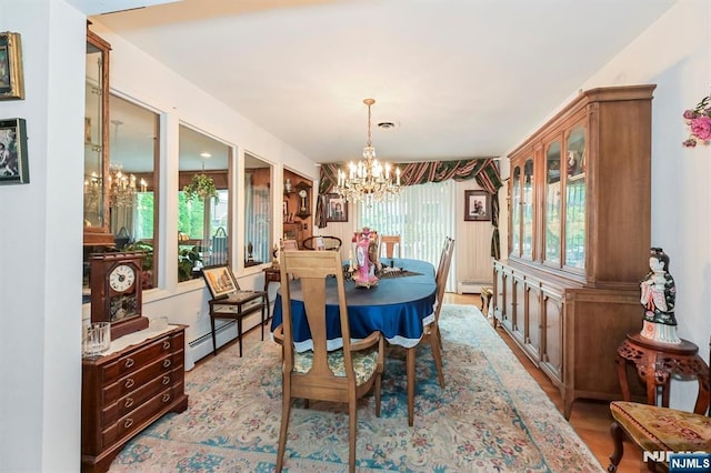 379 Mauro Rd, Englewood Cliffs, NJ 07632 - dining room featuring a chandelier, wood finished floors, and a baseboard heating unit