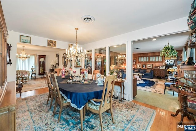 379 Mauro Rd, Englewood Cliffs, NJ 07632 - dining space featuring a chandelier, wood finished floors, and baseboard heating
