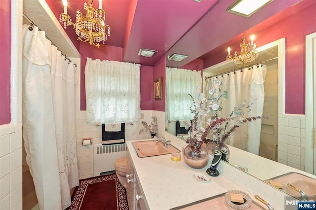 379 Mauro Rd, Englewood Cliffs, NJ 07632 - bathroom with radiator heating unit, tile walls, vanity, curtained shower, and wainscoting