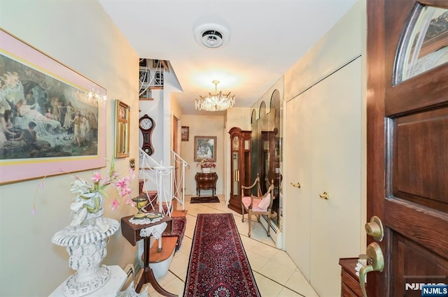 379 Mauro Rd, Englewood Cliffs, NJ 07632 - hall featuring light tile patterned floors and a chandelier