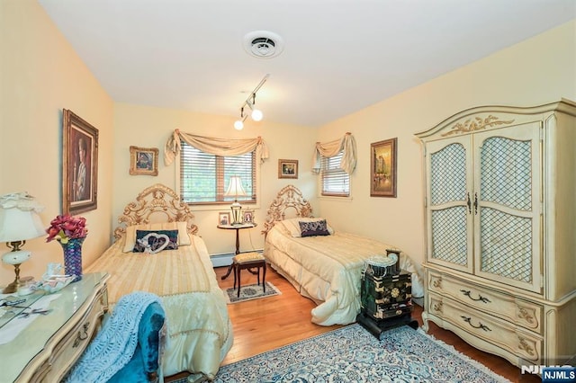 379 Mauro Rd, Englewood Cliffs, NJ 07632 - bedroom with a baseboard heating unit and wood finished floors
