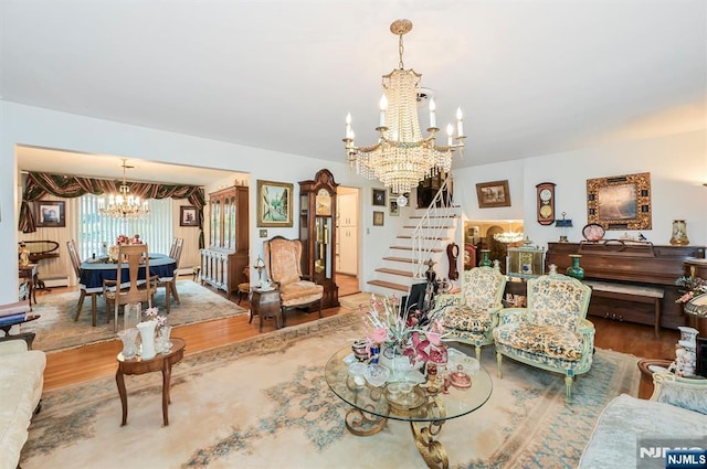 379 Mauro Rd, Englewood Cliffs, NJ 07632 - living area with a chandelier, wood finished floors, stairs, and a baseboard radiator