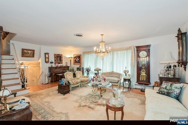 379 Mauro Rd, Englewood Cliffs, NJ 07632 - living area featuring a chandelier, wood finished floors, stairs, and a baseboard heating unit