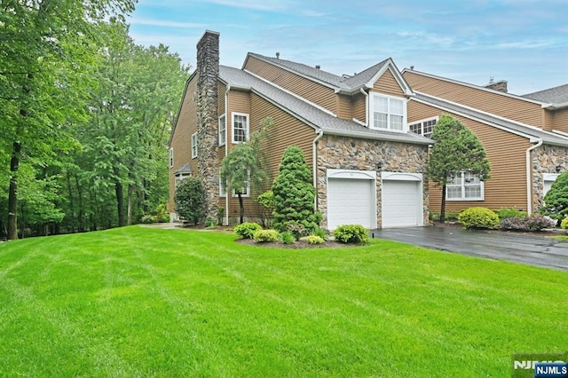 54 Hunter Rd, North Haledon, NJ 07508 - view of property exterior featuring stone siding, asphalt driveway, a chimney, a lawn, and a garage
