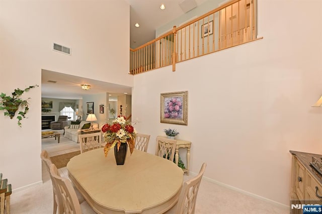54 Hunter Rd, North Haledon, NJ 07508 - dining area featuring light colored carpet, a high ceiling, baseboards, a fireplace, and recessed lighting