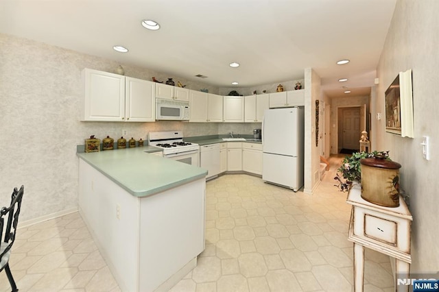 54 Hunter Rd, North Haledon, NJ 07508 - kitchen with white appliances, a sink, a peninsula, white cabinets, and recessed lighting