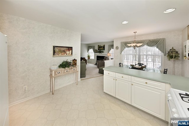 54 Hunter Rd, North Haledon, NJ 07508 - kitchen with range, white cabinets, light countertops, baseboards, and recessed lighting