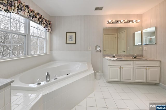 54 Hunter Rd, North Haledon, NJ 07508 - bathroom with double vanity, a garden tub, and tile patterned floors