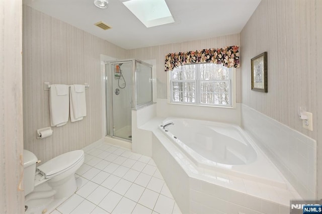 54 Hunter Rd, North Haledon, NJ 07508 - full bath with a skylight, tile patterned floors, toilet, a bath, and a stall shower