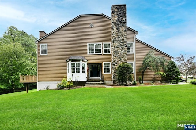 54 Hunter Rd, North Haledon, NJ 07508 - back of house featuring a chimney, a lawn, and entry steps